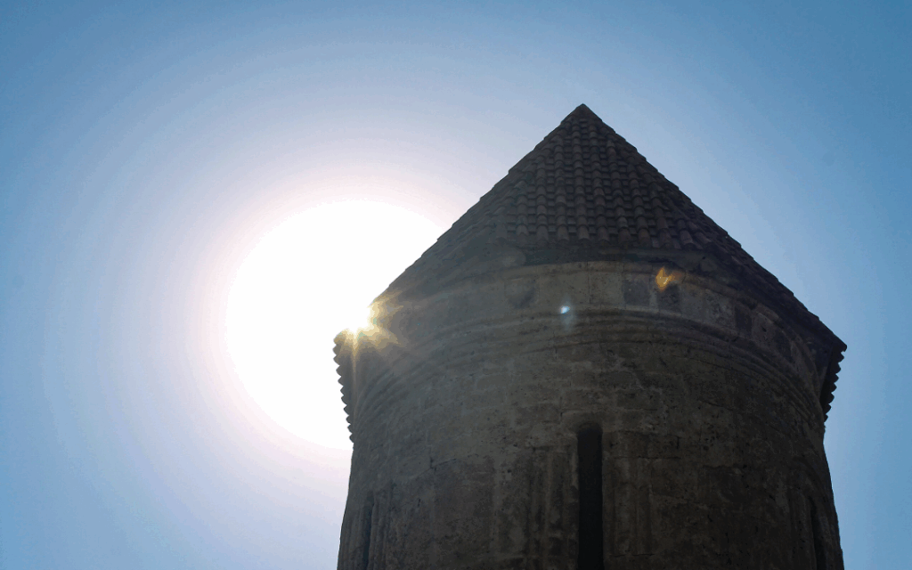The stone steeple of Kish Albanian Church in Shaki in the sunlight, representing some themes of the international conference on Christianity in Azerbaijan.